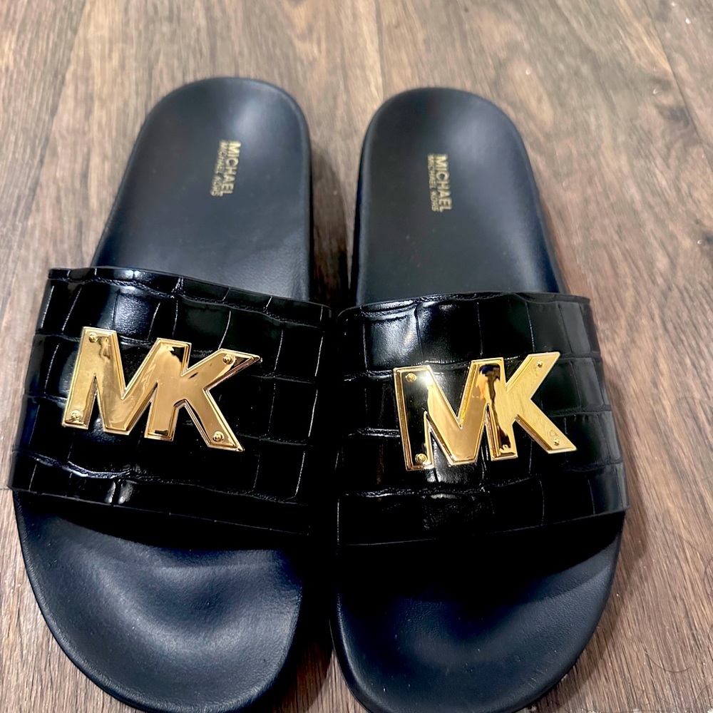 Never worn black and gold Michael Kors slides size 10.